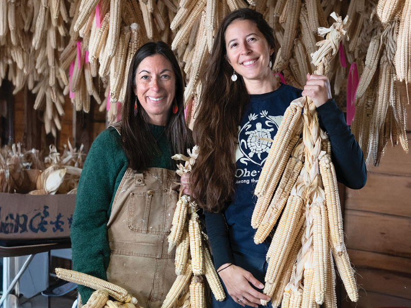 Jennifer Flack and Lea Zeise are members of the Ohe·láku, a nonprofit made up of Oneida families relearning how to grow traditional Tuscarora White Corn together. Credit: Stephanie Lee Stevens. Jennifer Flack and Lea Zeise are members of the Ohe·láku, a nonprofit made up of Oneida families relearning how to grow traditional Tuscarora White Corn together. Credit: Stephanie Lee Stevens.