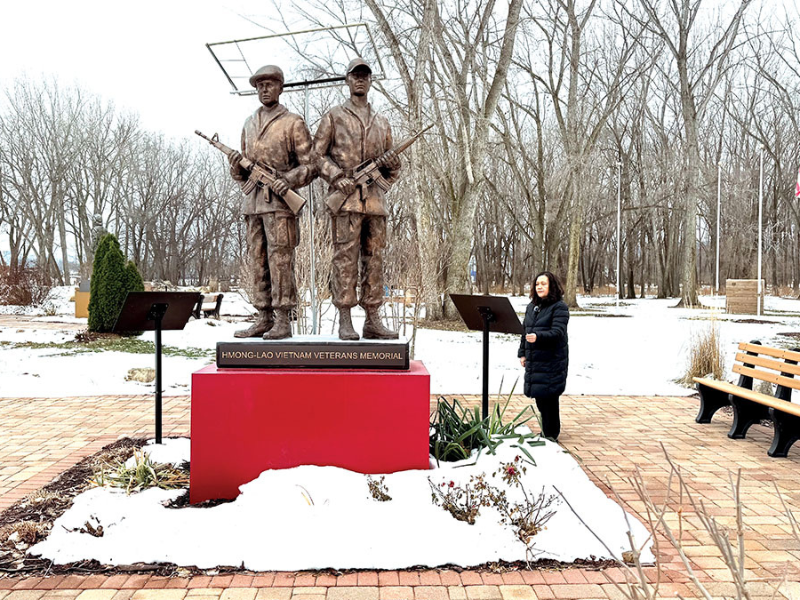The author standing next to the Hmong-Lao Vietnam Veterans Memorial in La Crosse. Credit: Flashe Yang. The author standing next to the Hmong-Lao Vietnam Veterans Memorial in La Crosse. Credit: Flashe Yang.