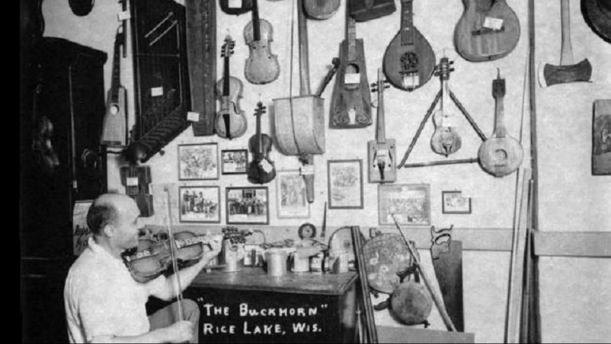 Otto Rindlisbacher, folk singer and maker of stringed instruments, sitting in his shop holding a Hardanger fiddle. Photo ca. 1941 by folklorist Helene Stratman-Thomas. Reprinted by permission of the Wisconsin Historical Society (WHS: #25413).