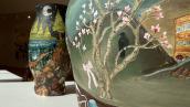 Detail image of ceramic vessel with cherry blossoms in art gallery setting