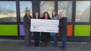 Karen Carlock (second from right) poses in front of the BECM with a donation from the State Bank of Cross Plains.