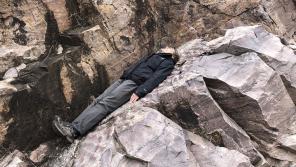 Marcia Bjornerud resting on a bed of quartzite near Baraboo.