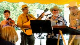 Above (l to r): Ruthie Krause, Rick Krause, a festival volunteer, and Ben Doran lead a group sing along at the 2013 Gandy Dancer Festival in Mazomanie.