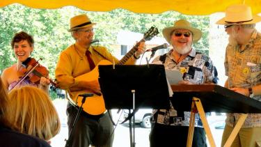 Above (l to r): Ruthie Krause, Rick Krause, a festival volunteer, and Ben Doran lead a group sing along at the 2013 Gandy Dancer Festival in Mazomanie.