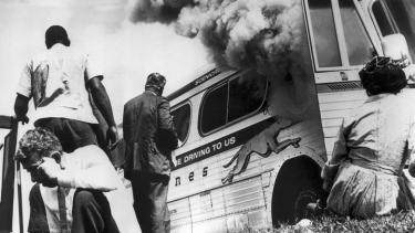 A "Freedom Bus" in flames, six miles southwest of Anniston, Alabama, May 14, 1961. (Birmingham Public Library/Oxford University Press)